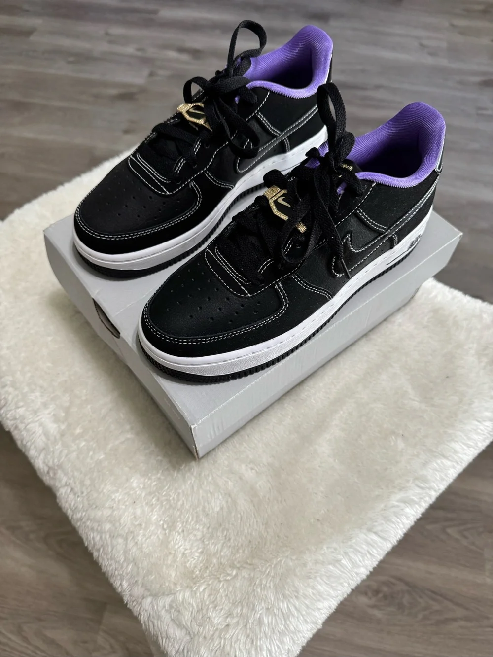 Nike Kids Black Sneakers with Purple Lining and Gold Lace Accent